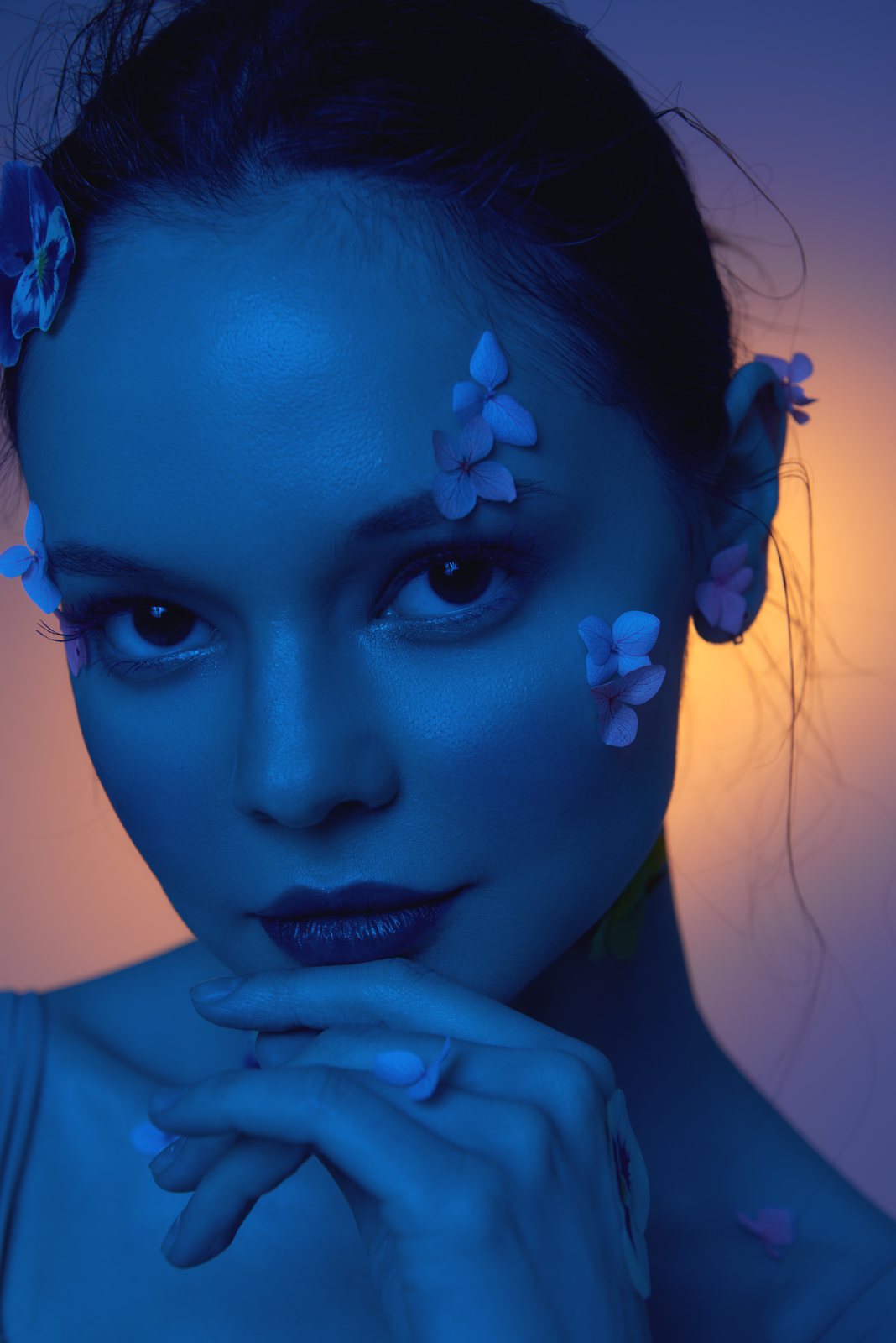 Beauty portrait with petals on the skin