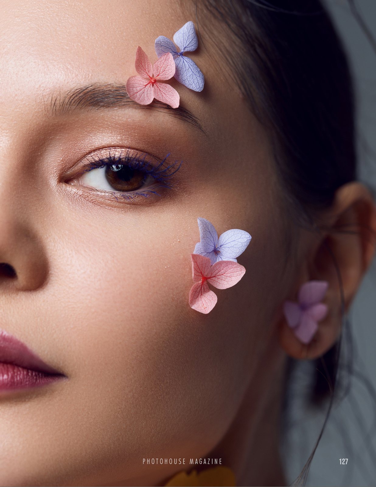 Beauty portrait with petals on the skin
